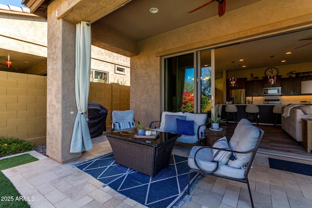 view of patio with ceiling fan, an outdoor hangout area, and area for grilling