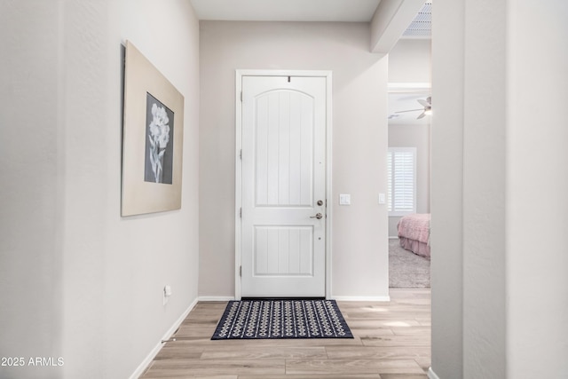 doorway to outside featuring ceiling fan and light hardwood / wood-style floors