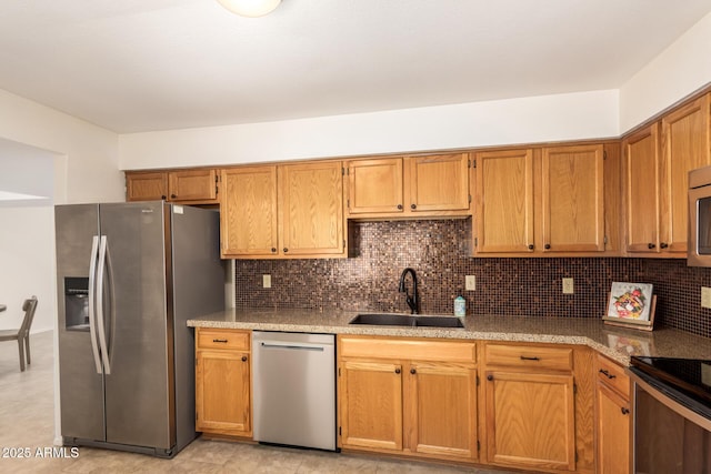 9460 E Mission Ln Unit 115, Scottsdale, AZ 85258 - kitchen featuring stainless steel appliances, decorative backsplash, and brown cabinetry