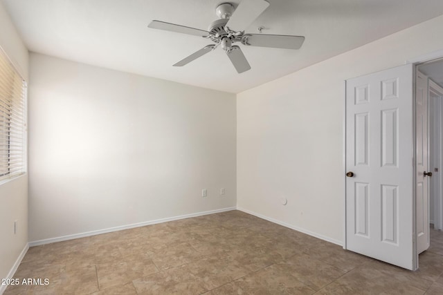 9460 E Mission Ln Unit 115, Scottsdale, AZ 85258 - unfurnished bedroom with baseboards and a ceiling fan