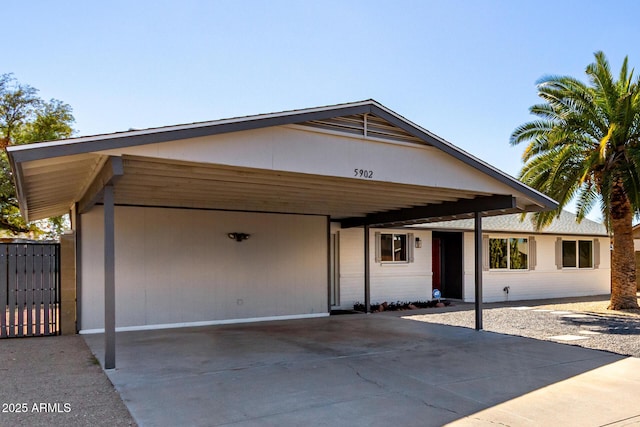 view of front of home featuring driveway and an attached carport