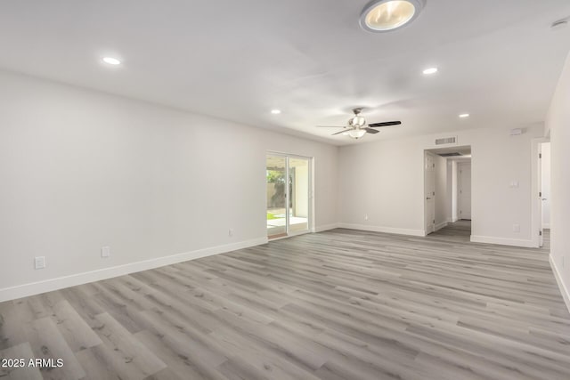 spare room featuring light wood finished floors, ceiling fan, baseboards, and recessed lighting