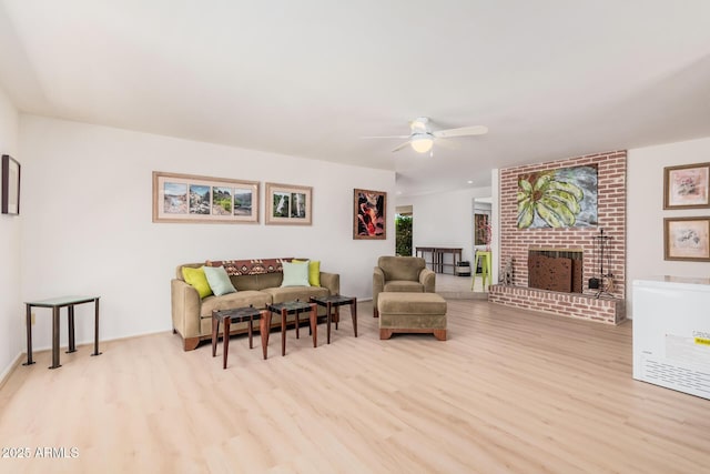 6802 N 26th St, Phoenix, AZ 85016 - living room with wood finished floors, a ceiling fan, and a brick fireplace