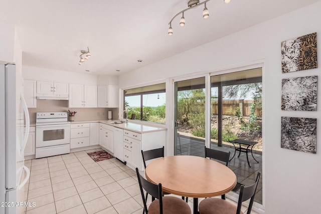 6802 N 26th St, Phoenix, AZ 85016 - kitchen featuring white appliances, under cabinet range hood, white cabinets, and light tile patterned floors
