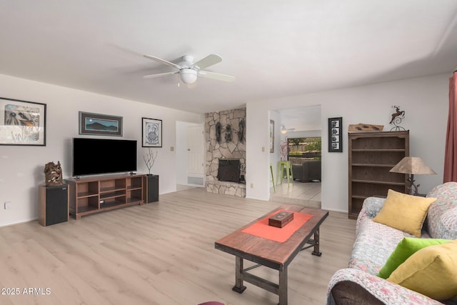 6802 N 26th St, Phoenix, AZ 85016 - living area featuring wood finished floors, a ceiling fan, and a fireplace