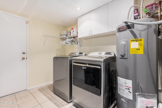 6802 N 26th St, Phoenix, AZ 85016 - laundry room with electric water heater, cabinet space, washing machine and dryer, and light tile patterned flooring