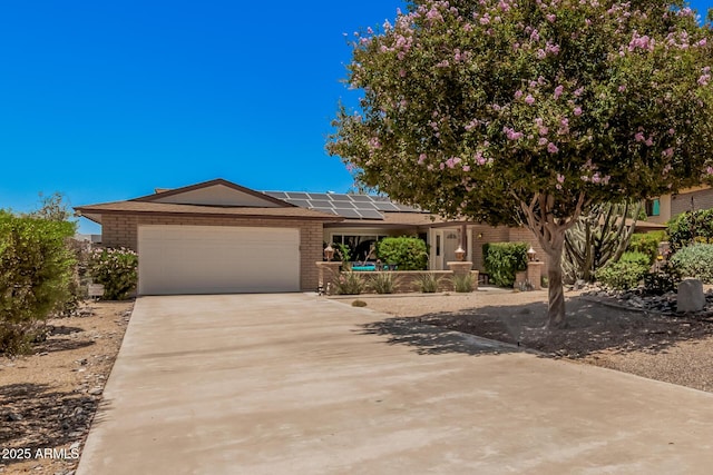 6802 N 26th St, Phoenix, AZ 85016 - single story home featuring brick siding, solar panels, a garage, and driveway