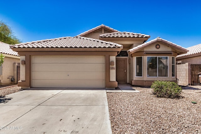 16120 N 86th Ln, Peoria, AZ 85382 - view of front of house with an attached garage, driveway, a tile roof, and stucco siding
