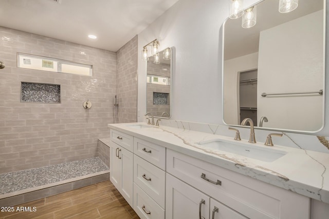 16120 N 86th Ln, Peoria, AZ 85382 - full bathroom featuring a tile shower, double vanity, wood finished floors, and a walk in closet