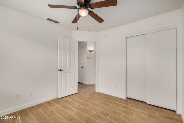 16120 N 86th Ln, Peoria, AZ 85382 - unfurnished bedroom featuring baseboards, light wood-type flooring, ceiling fan, and a closet