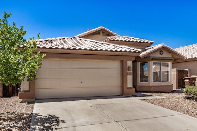 16120 N 86th Ln, Peoria, AZ 85382 - view of front of home featuring concrete driveway, a garage, a tile roof, and stucco siding