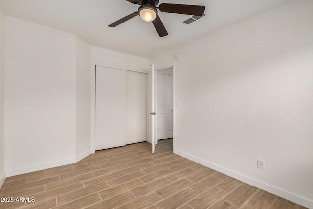 16120 N 86th Ln, Peoria, AZ 85382 - unfurnished bedroom with baseboards, light wood-style flooring, a closet, and a ceiling fan