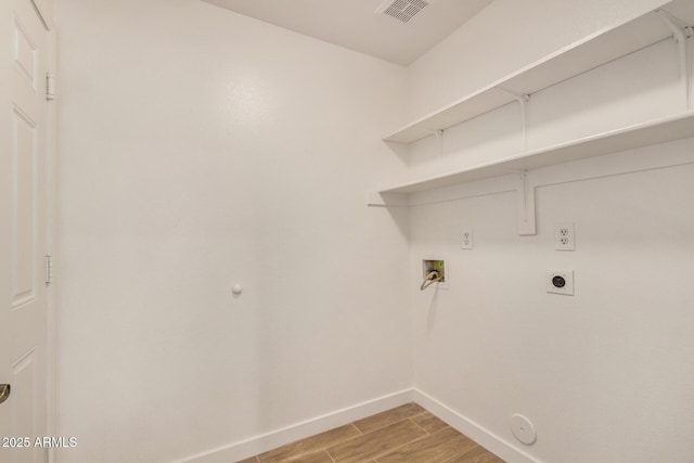 16120 N 86th Ln, Peoria, AZ 85382 - laundry area with hookup for a gas dryer, hookup for a washing machine, light wood finished floors, baseboards, and hookup for an electric dryer