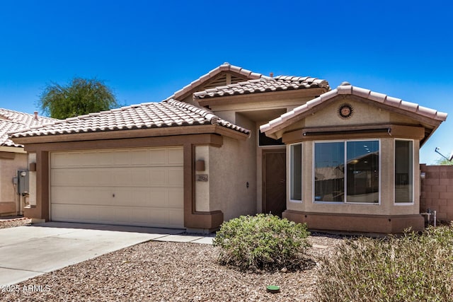 16120 N 86th Ln, Peoria, AZ 85382 - view of front of home featuring a tiled roof, an attached garage, concrete driveway, and stucco siding