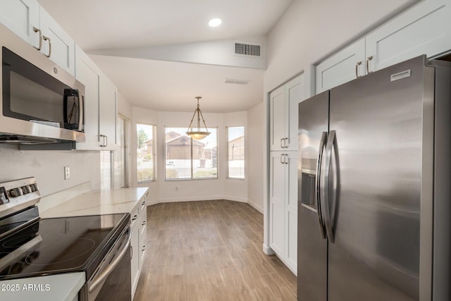 16120 N 86th Ln, Peoria, AZ 85382 - kitchen featuring stainless steel appliances, lofted ceiling, white cabinets, light wood-type flooring, and baseboards