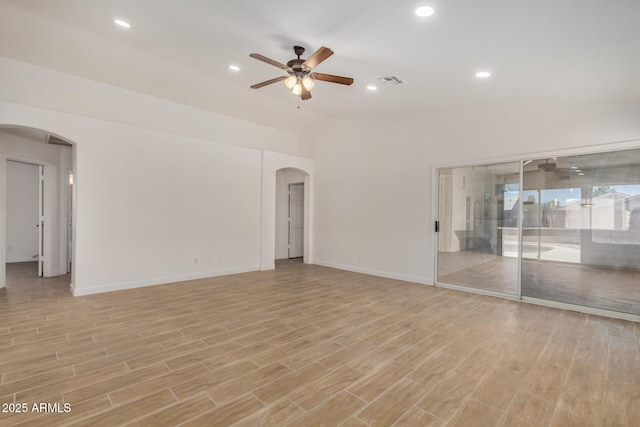 16120 N 86th Ln, Peoria, AZ 85382 - empty room featuring arched walkways, a ceiling fan, light wood-type flooring, baseboards, and recessed lighting