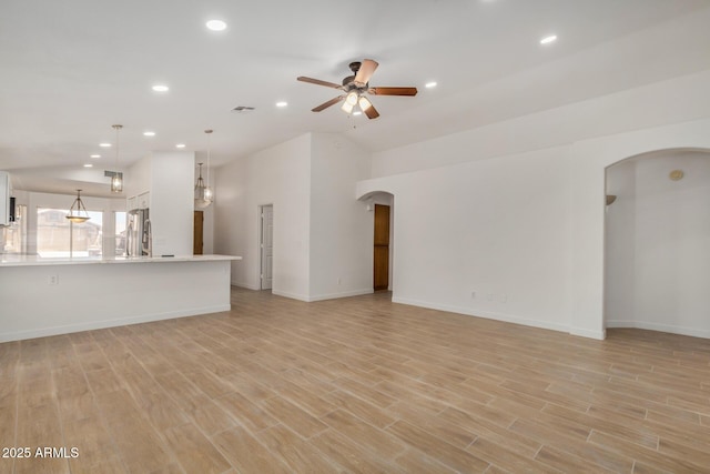 16120 N 86th Ln, Peoria, AZ 85382 - unfurnished living room with ceiling fan, arched walkways, recessed lighting, light wood finished floors, and baseboards