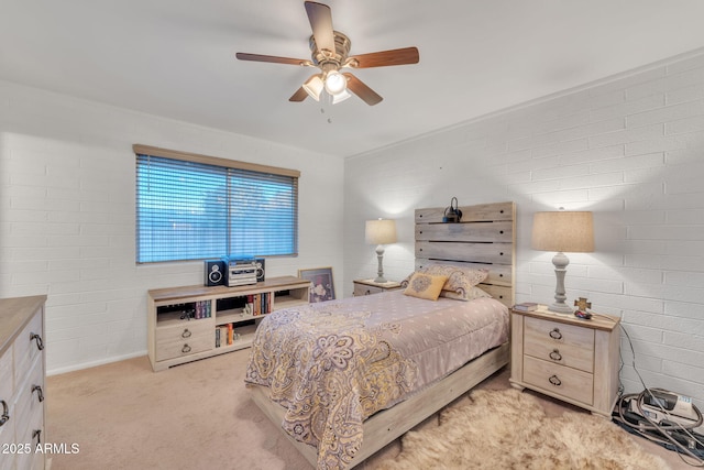 bedroom featuring ceiling fan, brick wall, and light colored carpet