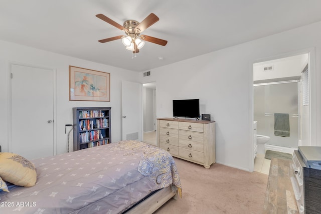 carpeted bedroom with ceiling fan and ensuite bathroom