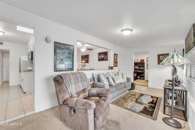 living room featuring ceiling fan and light colored carpet