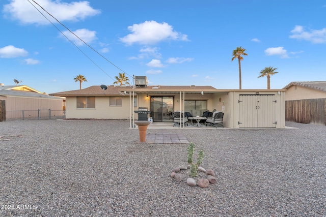 rear view of house featuring central AC unit and a patio