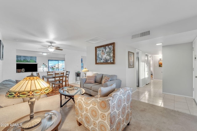 tiled living room with ceiling fan