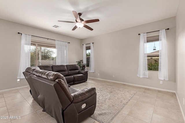 tiled living room with ceiling fan