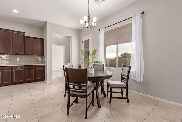 dining room featuring light tile patterned floors and a chandelier