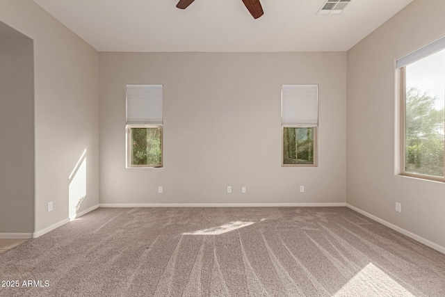 carpeted empty room featuring ceiling fan