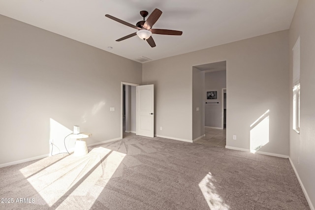 unfurnished room featuring ceiling fan and light carpet