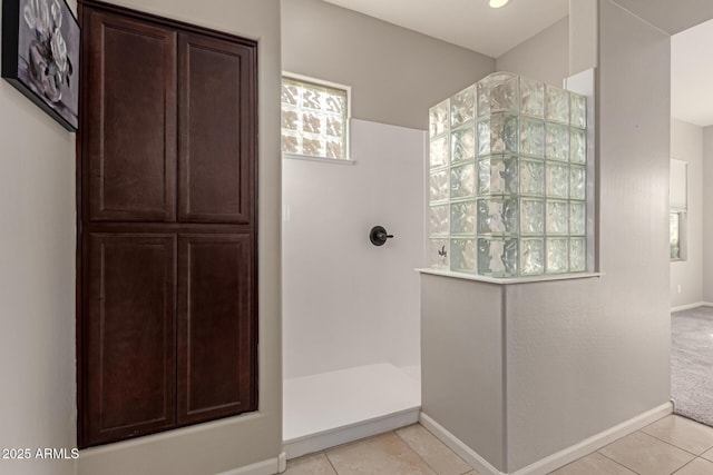 bathroom featuring tile patterned flooring and walk in shower