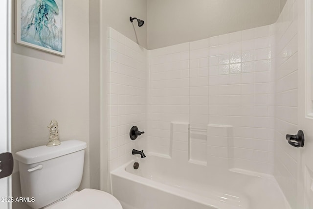 bathroom featuring bathtub / shower combination and toilet