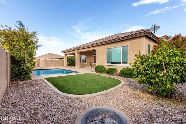 back of house with a fenced in pool and a patio area