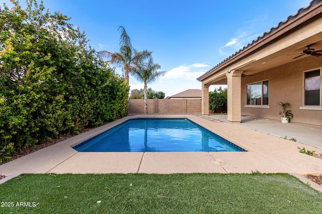 view of swimming pool with ceiling fan and a patio area