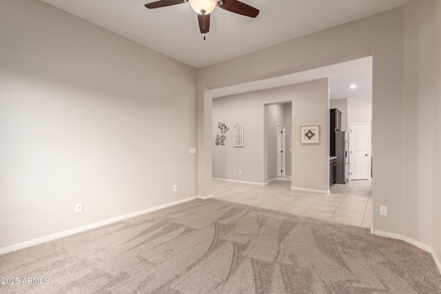 carpeted empty room with ceiling fan