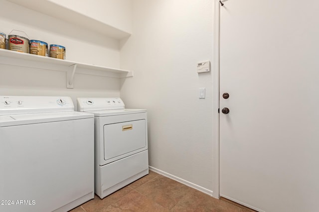 laundry area with independent washer and dryer and light tile patterned floors