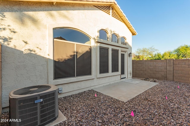 rear view of property featuring cooling unit and a patio