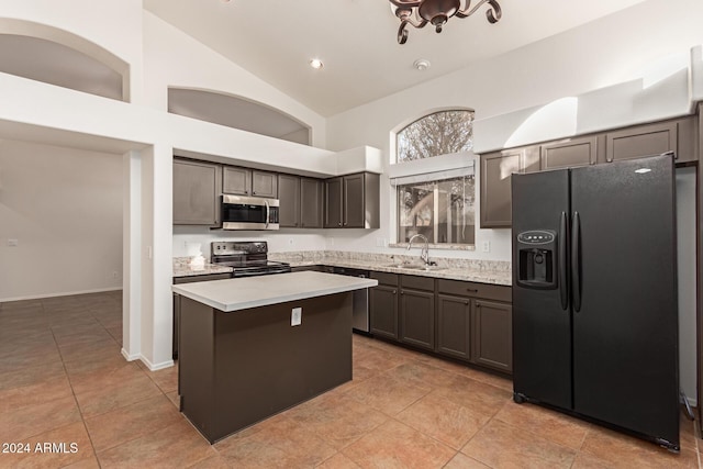 kitchen featuring high vaulted ceiling, black appliances, sink, light tile patterned floors, and a kitchen island