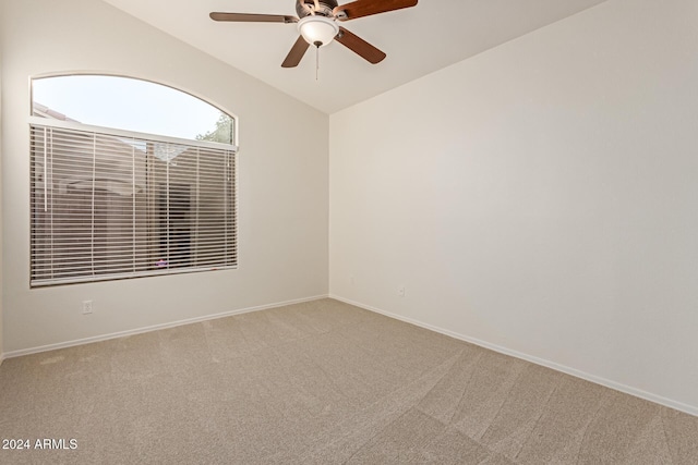 spare room with carpet flooring, ceiling fan, and lofted ceiling