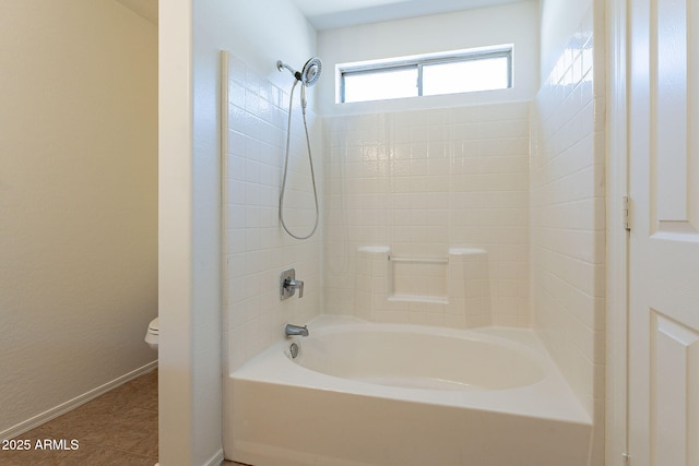 bathroom featuring toilet, baseboards, tub / shower combination, and tile patterned floors