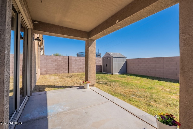 view of patio / terrace featuring a fenced backyard, a storage unit, and an outdoor structure