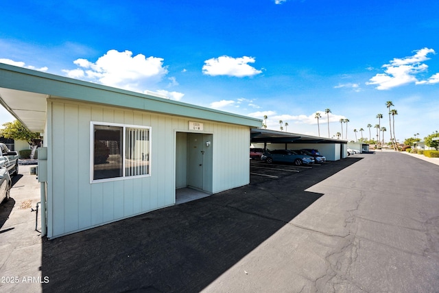 exterior space featuring covered parking