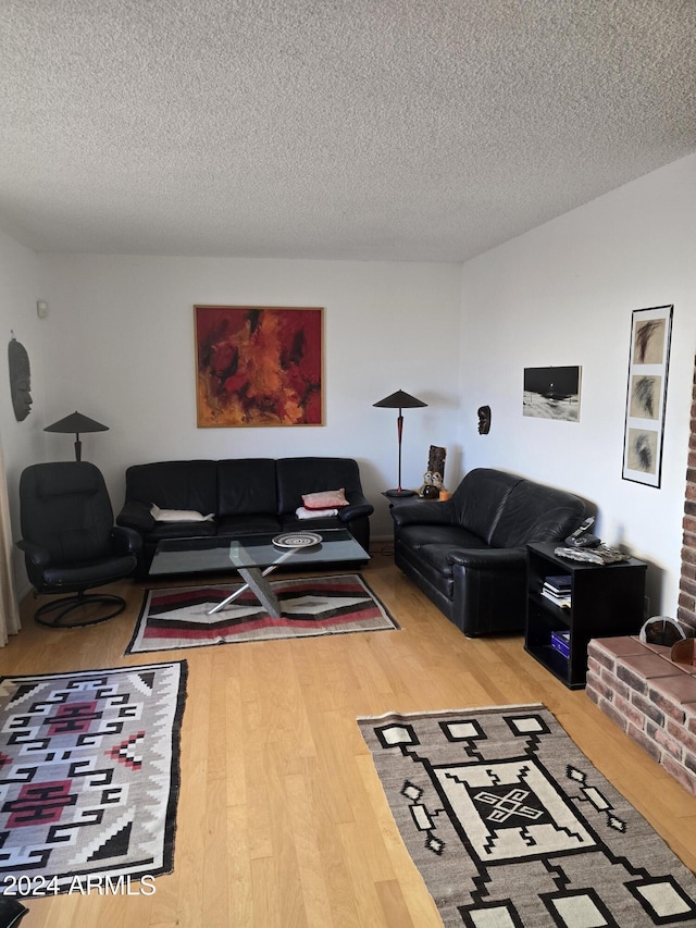 living room featuring hardwood / wood-style floors and a textured ceiling