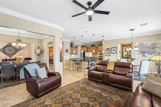 living room featuring ceiling fan with notable chandelier and ornamental molding