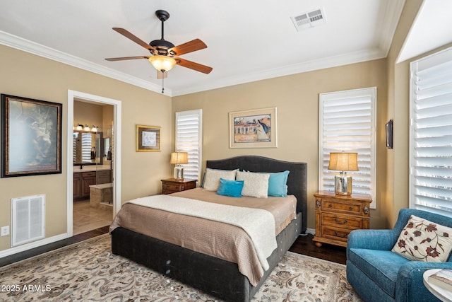 bedroom featuring ceiling fan, hardwood / wood-style floors, ornamental molding, and ensuite bath