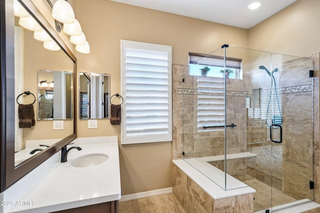 bathroom with a shower with door and vanity