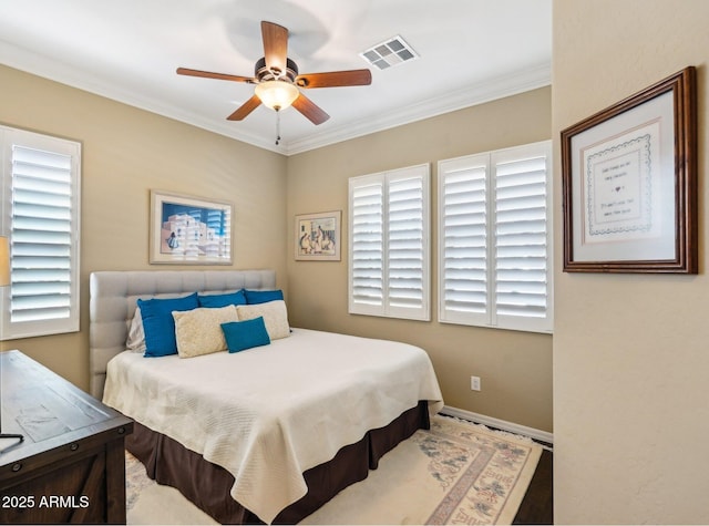 bedroom with ceiling fan and crown molding