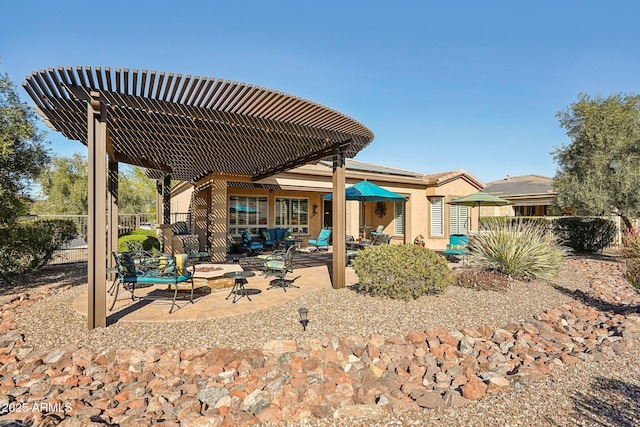 rear view of house featuring a patio area and a pergola