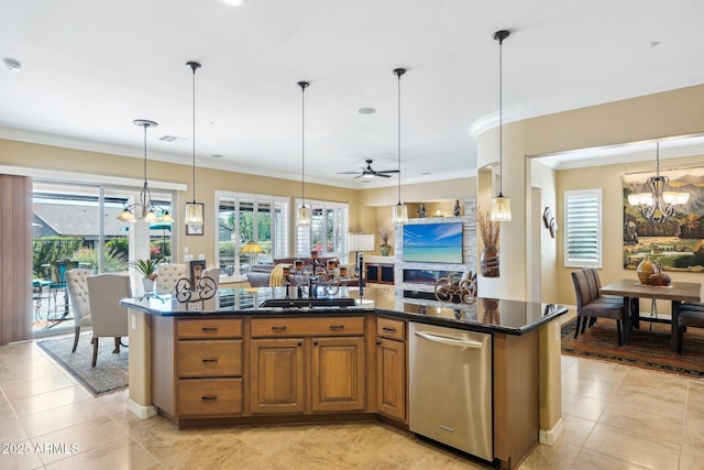 kitchen with a center island, hanging light fixtures, stainless steel dishwasher, sink, and ceiling fan with notable chandelier