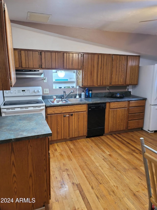 kitchen with light wood-type flooring, white appliances, vaulted ceiling, and sink